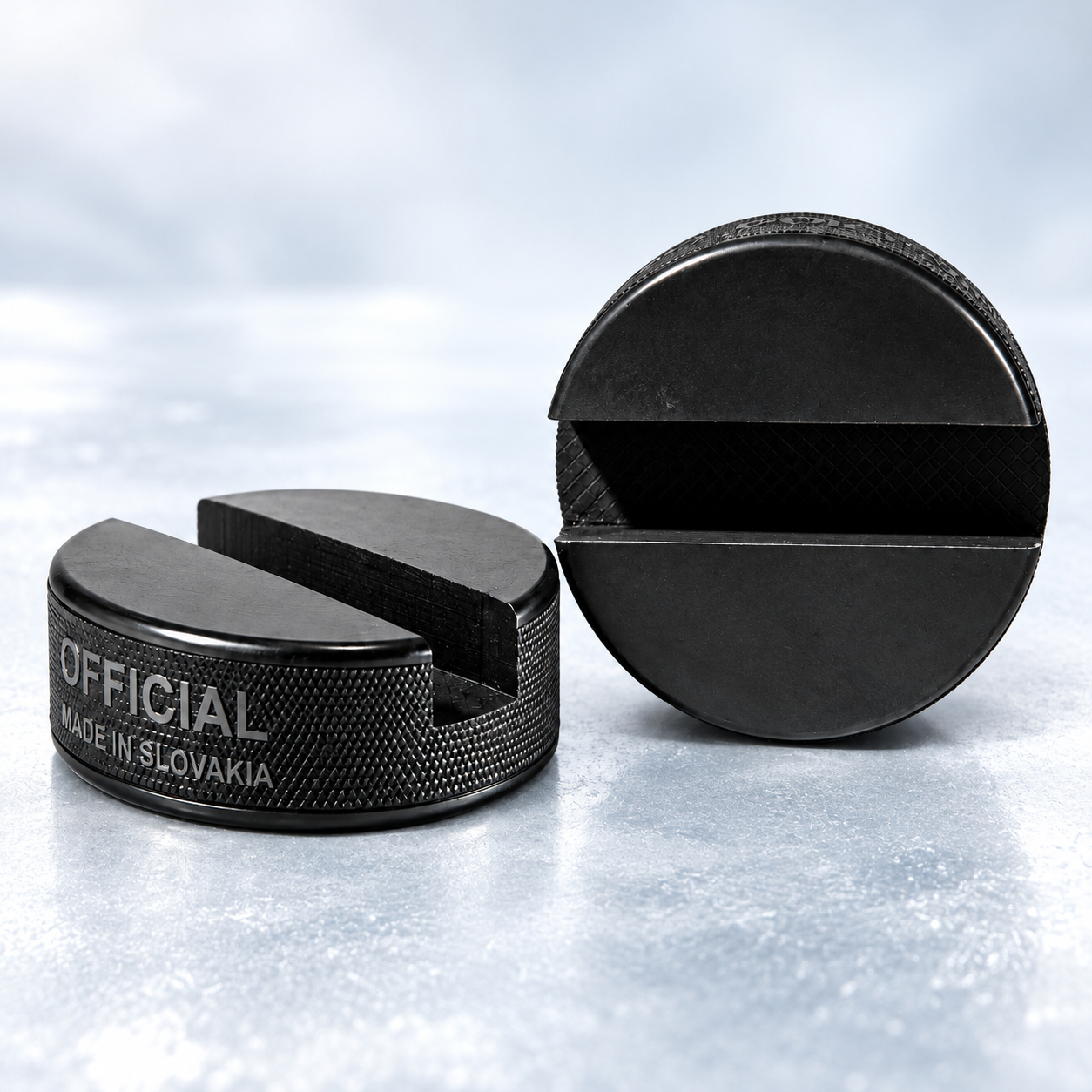 Two authentic PUCKUPS stands showcasing the precision-machined phone slot on an ice-blue surface